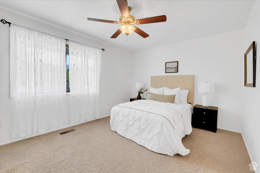 Bedroom with carpet floors and a ceiling fan