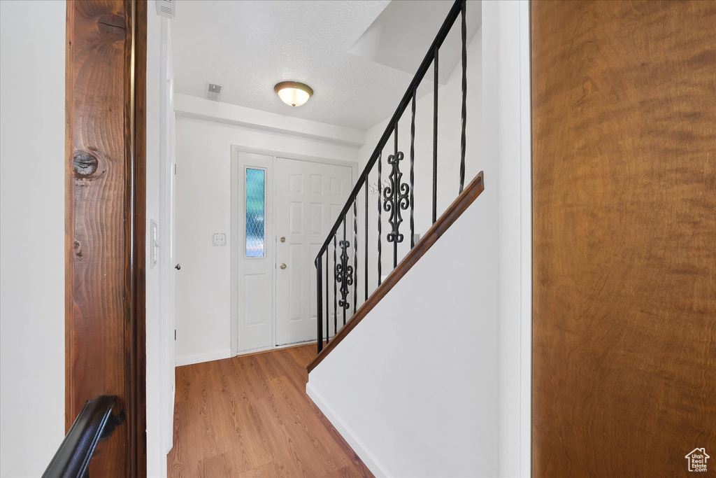 Entryway featuring wood finished floors and stairs