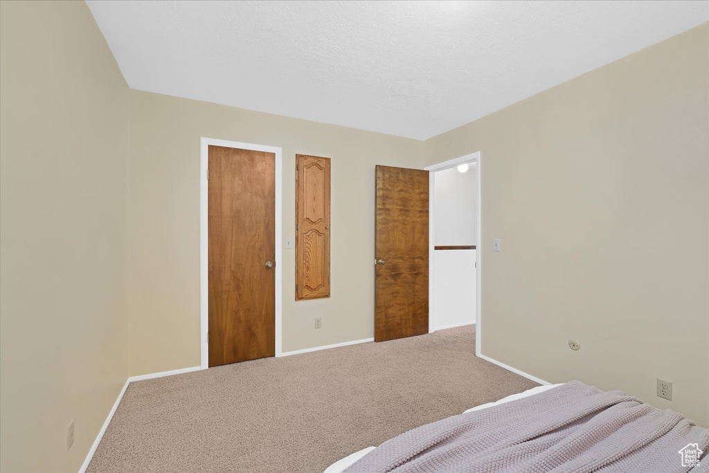 Carpeted bedroom featuring baseboards