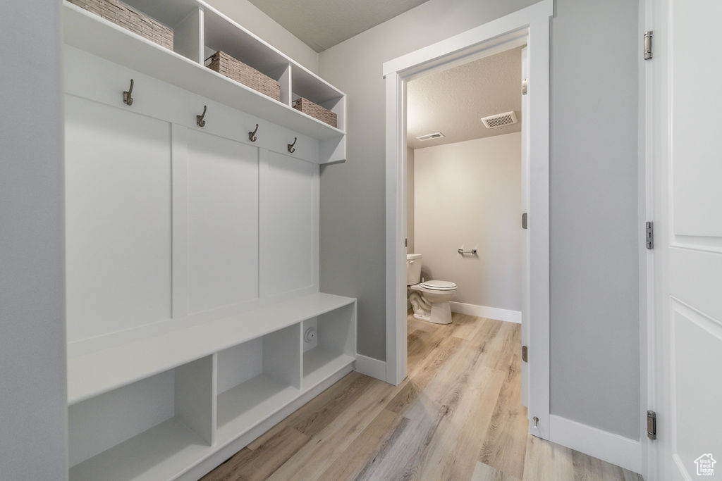 Mudroom featuring light wood-type flooring and baseboards