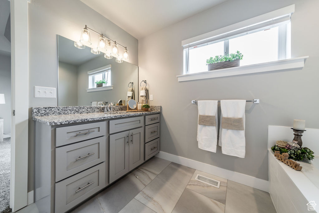 Bathroom featuring vanity and baseboards