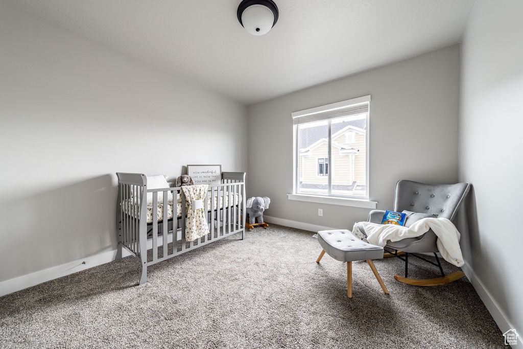 Carpeted bedroom featuring baseboards