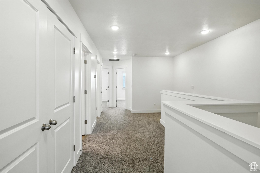 Corridor with carpet and recessed lighting