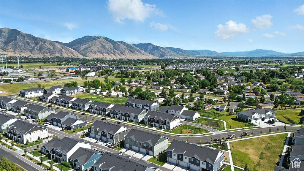 Aerial view of property's location featuring a mountainous background and nearby suburban area