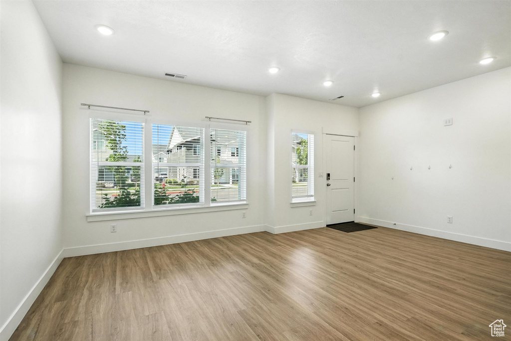 Entrance foyer featuring plenty of natural light, wood finished floors, and recessed lighting