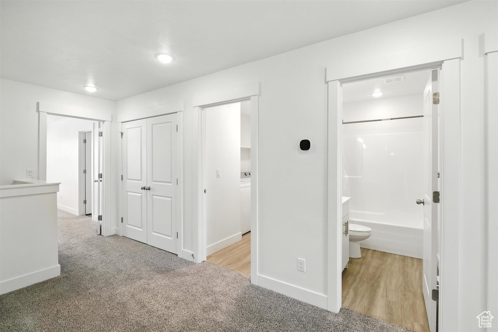 Hallway with carpet and recessed lighting