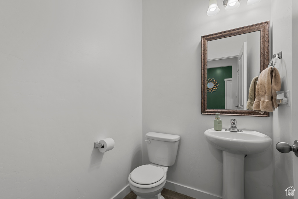 Half bath with toilet and baseboards