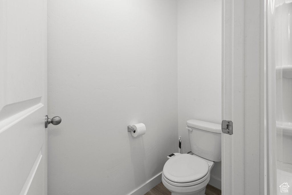 Bathroom featuring toilet and wood finished floors