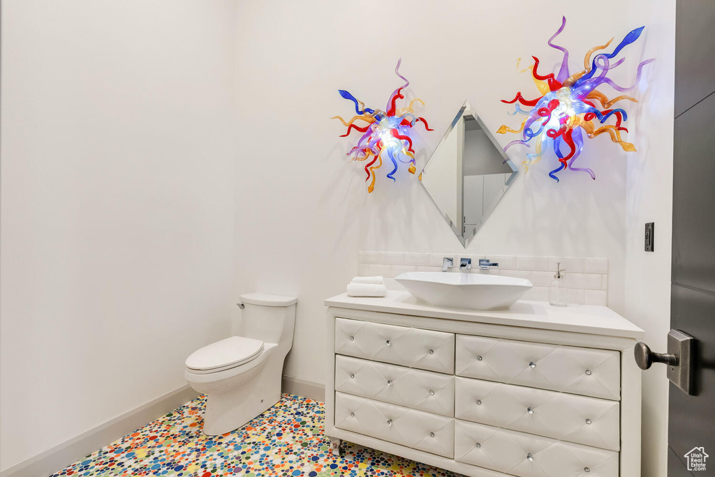 Half bath featuring toilet and vanity