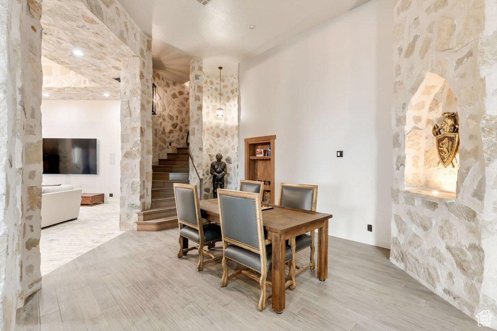 Dining space featuring stairway and wood finished floors