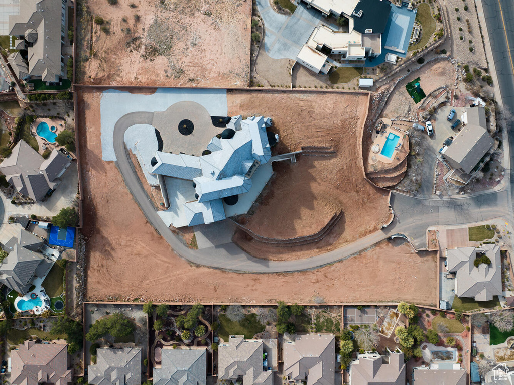 Aerial view of property's location with nearby suburban area and a pool