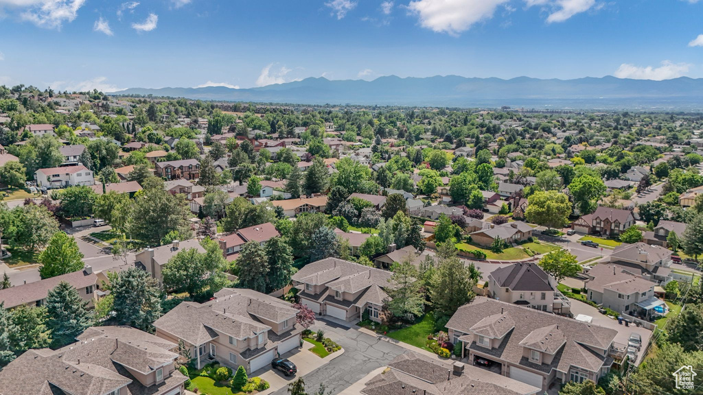 Aerial perspective of suburban area featuring a mountain backdrop
