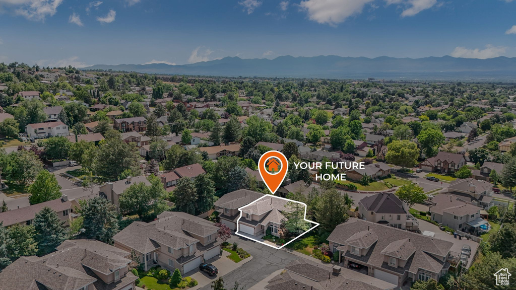 Aerial view of residential area with mountains and property boundaries highlighted