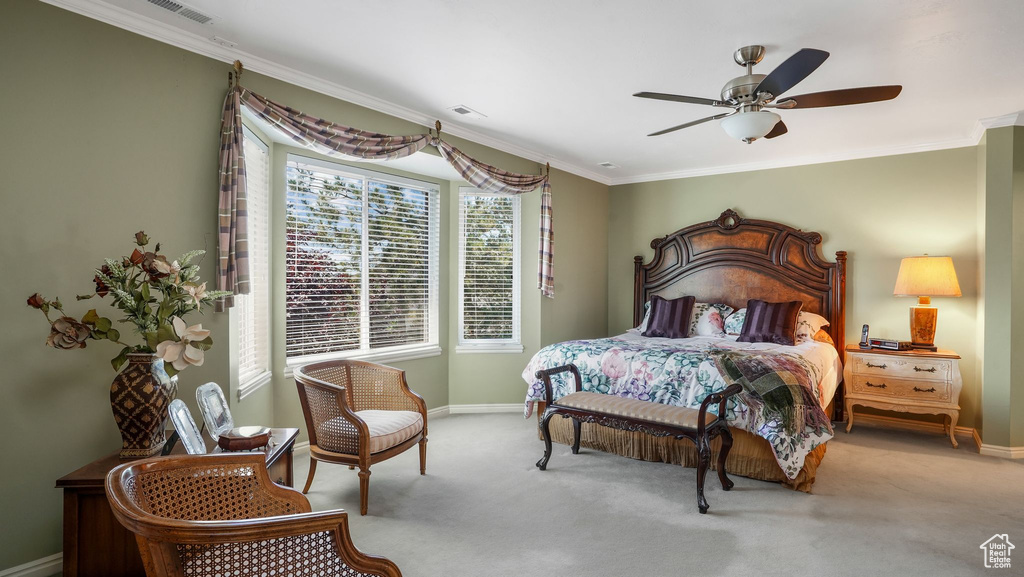 Bedroom featuring carpet floors, ornamental molding, and ceiling fan