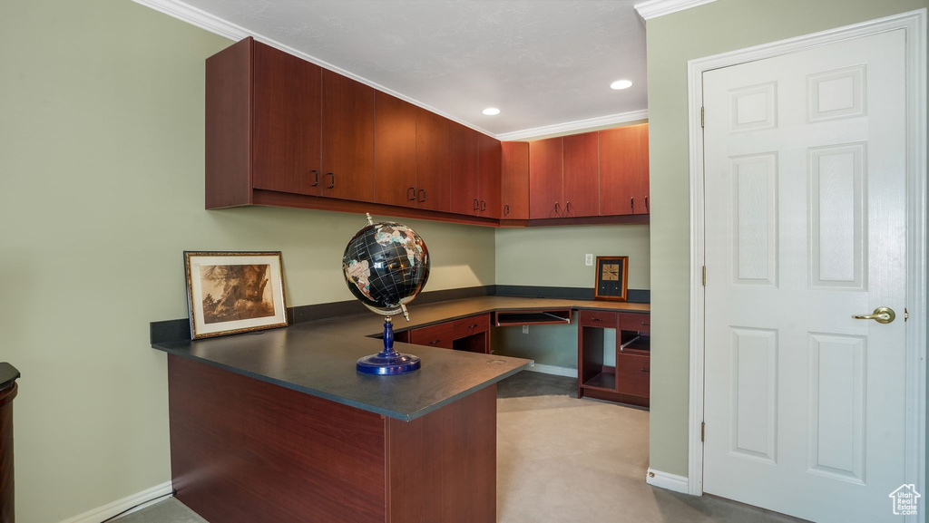 Home office with built in study area, recessed lighting, and ornamental molding