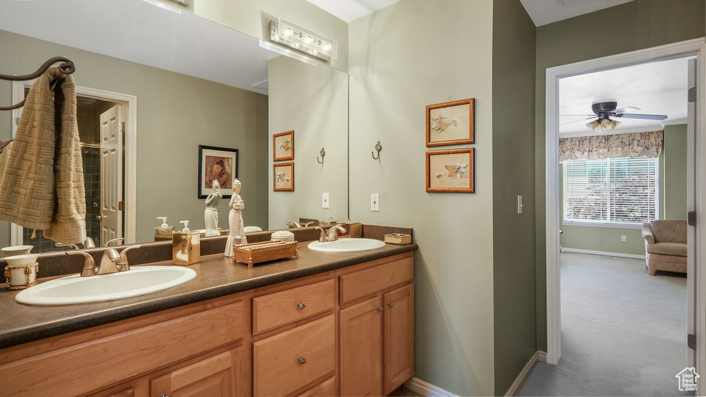 Full bath featuring double vanity and a ceiling fan