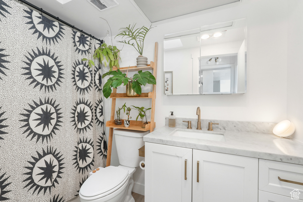 Bathroom featuring vanity and a shower with shower curtain