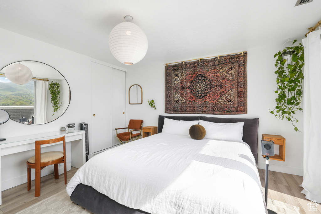 Bedroom featuring light wood-type flooring and a closet