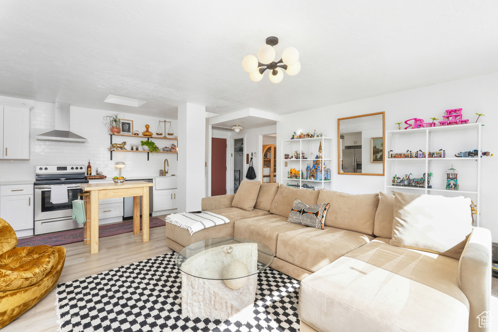 Living area featuring light floors and a chandelier