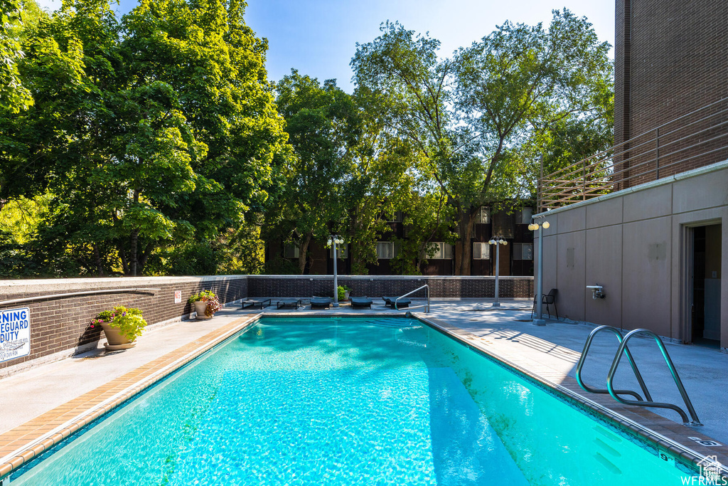 View of swimming pool featuring a patio area