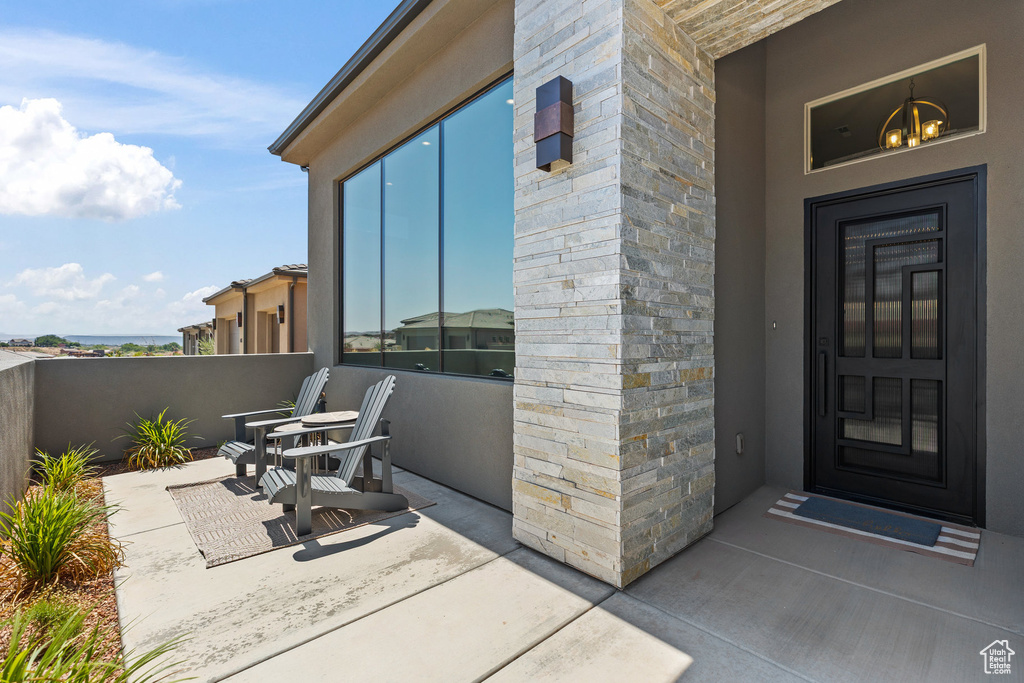 Property entrance featuring stone siding and stucco siding