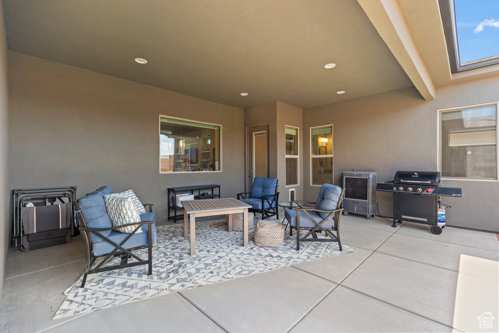 View of patio featuring a grill and an outdoor hangout area