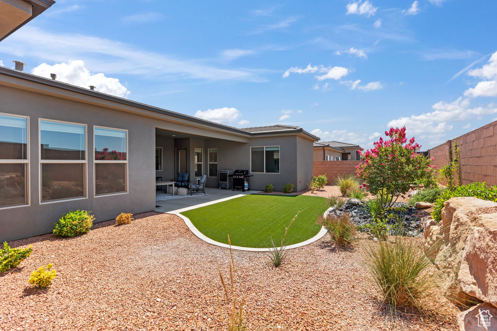 Fenced backyard featuring a patio area