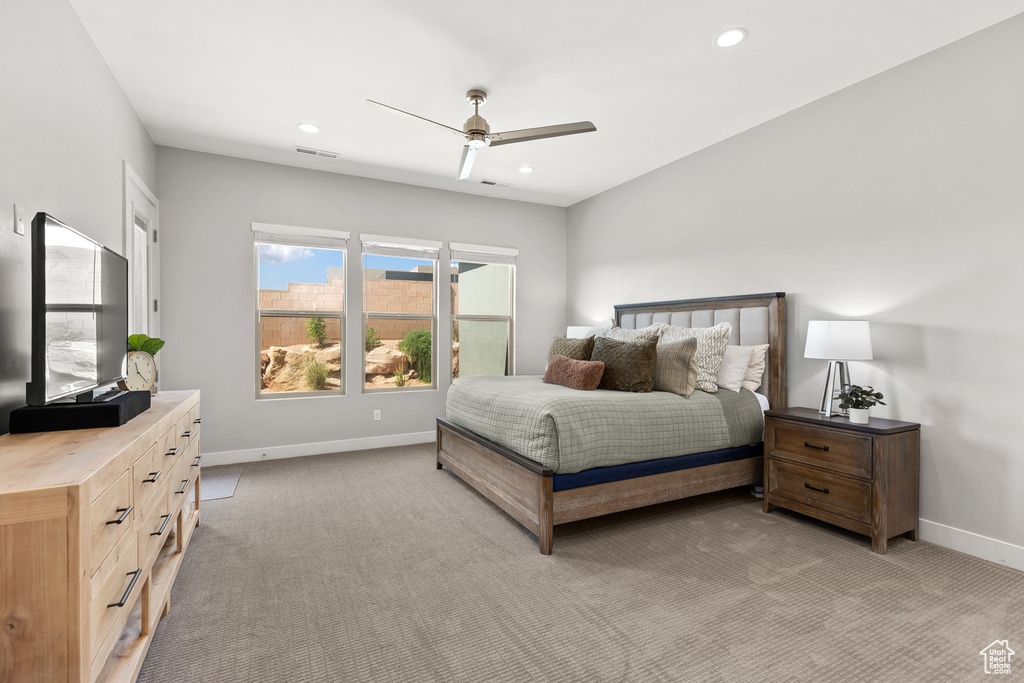 Bedroom with light colored carpet, recessed lighting, and a ceiling fan