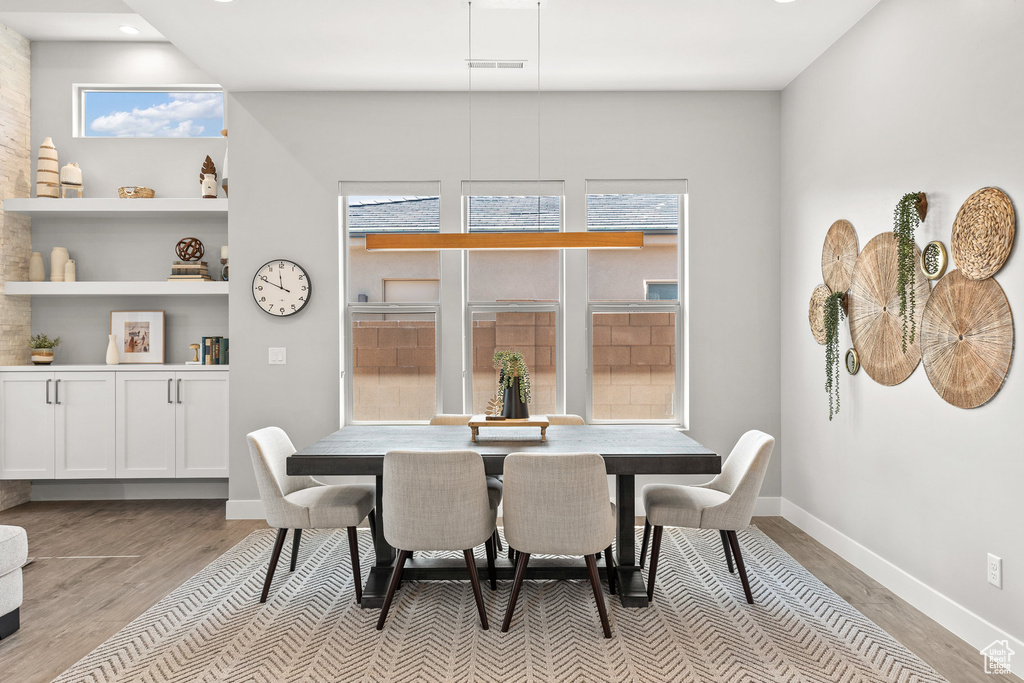 Dining area featuring light wood-style floors, healthy amount of natural light, and recessed lighting