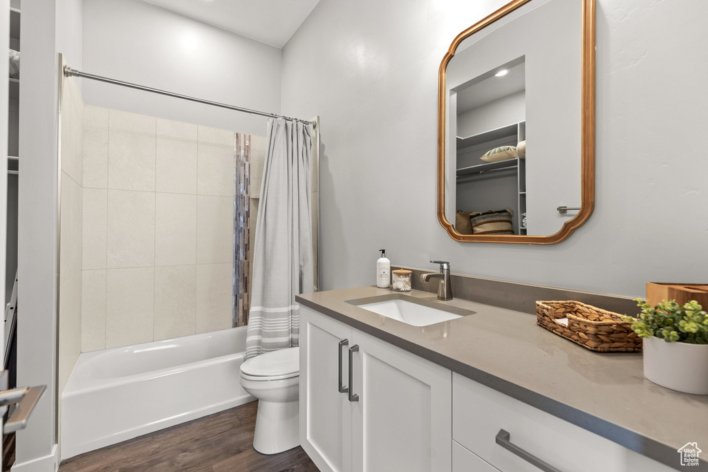 Full bathroom featuring vanity, wood finished floors, and shower / bath combo
