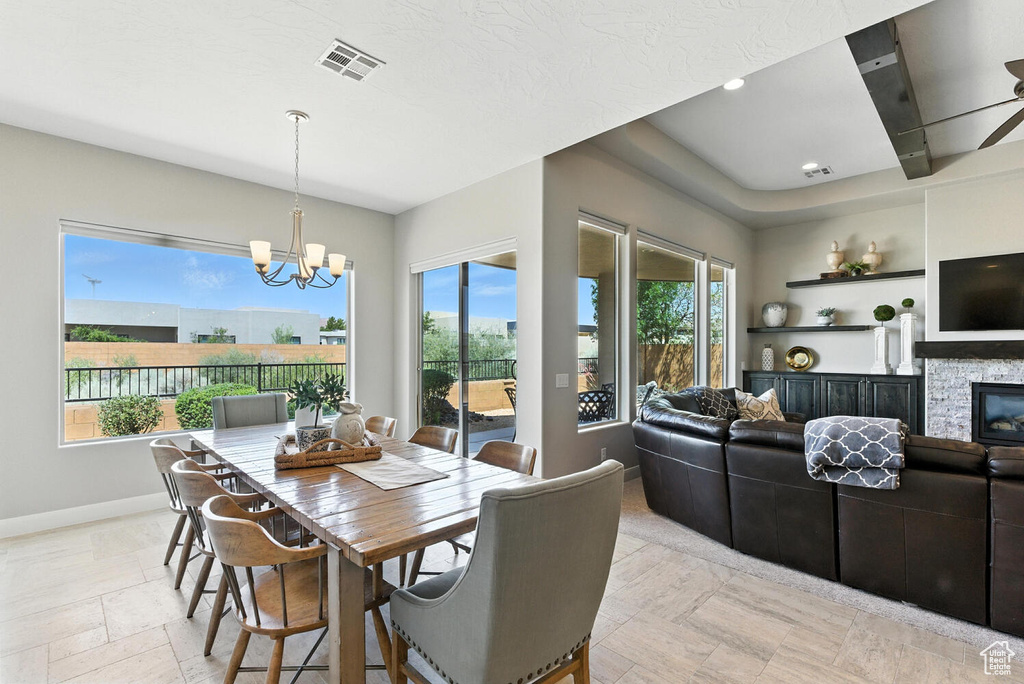 Dining area featuring a chandelier and a fireplace