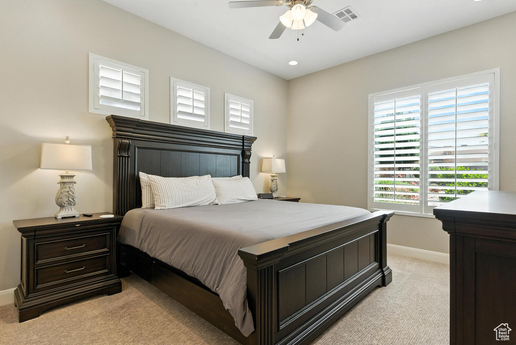 Bedroom featuring light carpet, multiple windows, ceiling fan, and recessed lighting