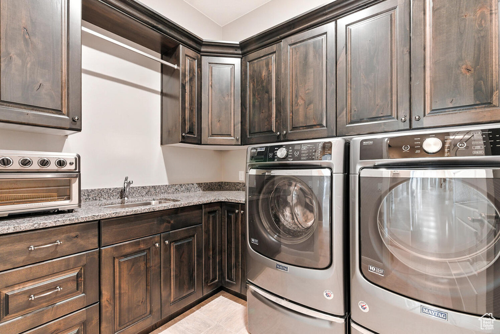 Laundry area with independent washer and dryer and a sink