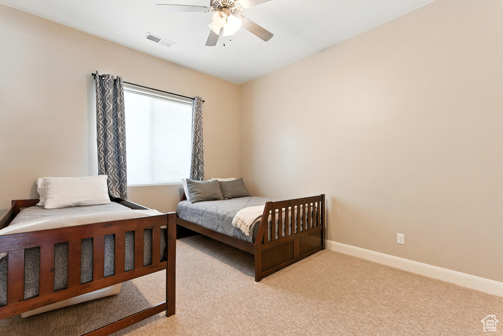 Bedroom with light carpet and ceiling fan