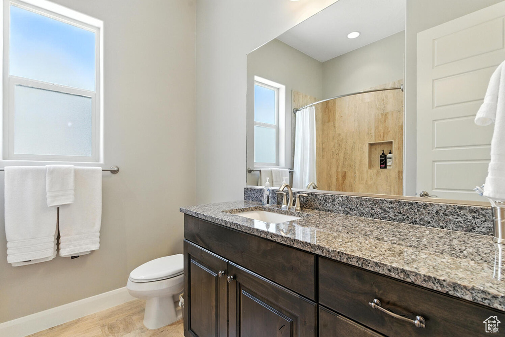 Full bath with vanity and a shower with curtain