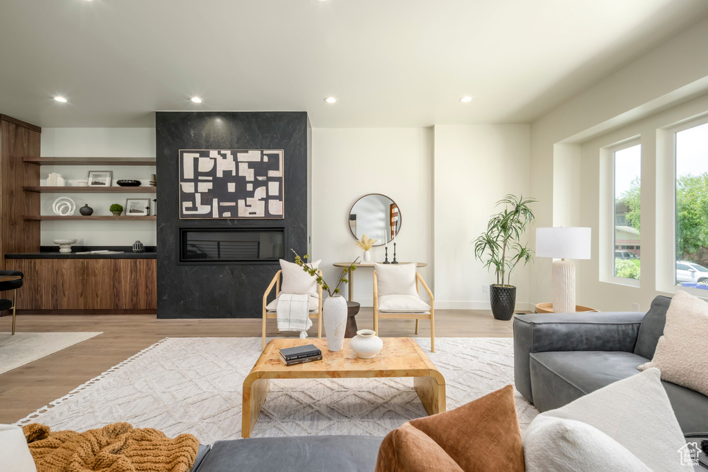 Living area featuring light wood finished floors and recessed lighting
