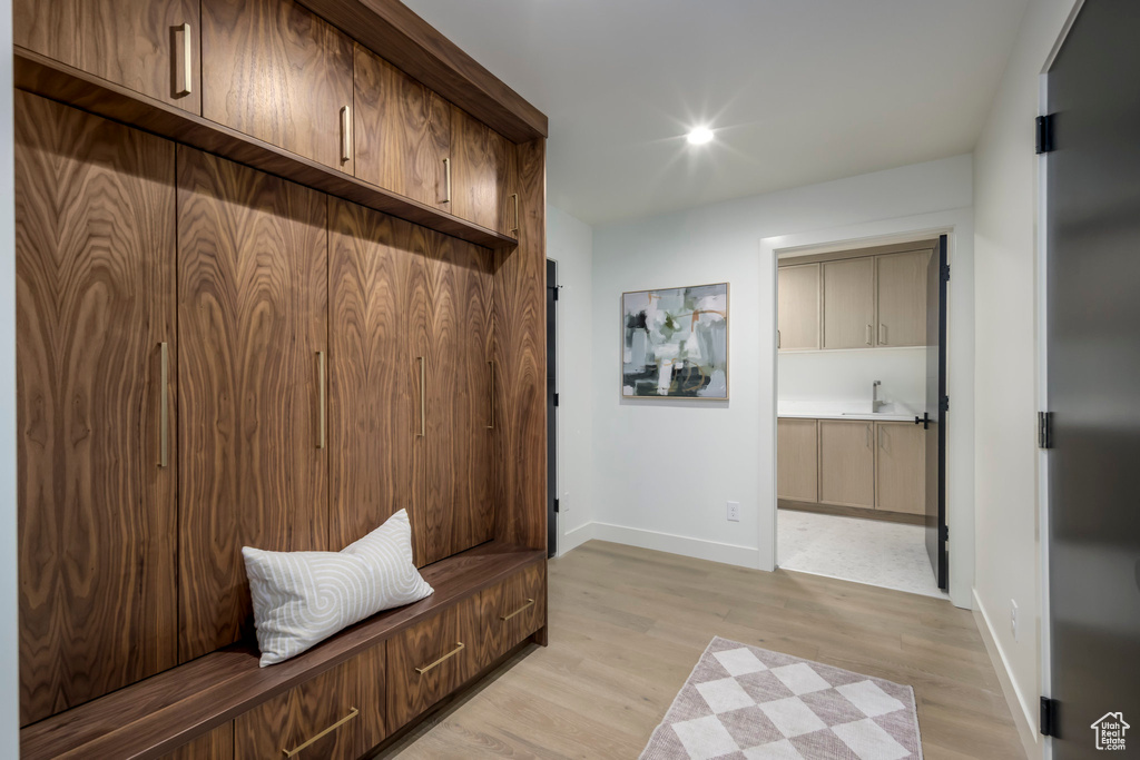 Mudroom with baseboards and light wood finished floors