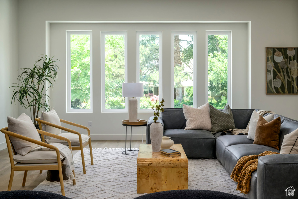 Living area with baseboards and wood finished floors