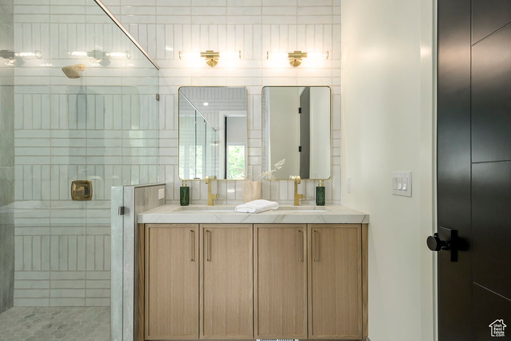 Bathroom featuring double vanity and a stall shower