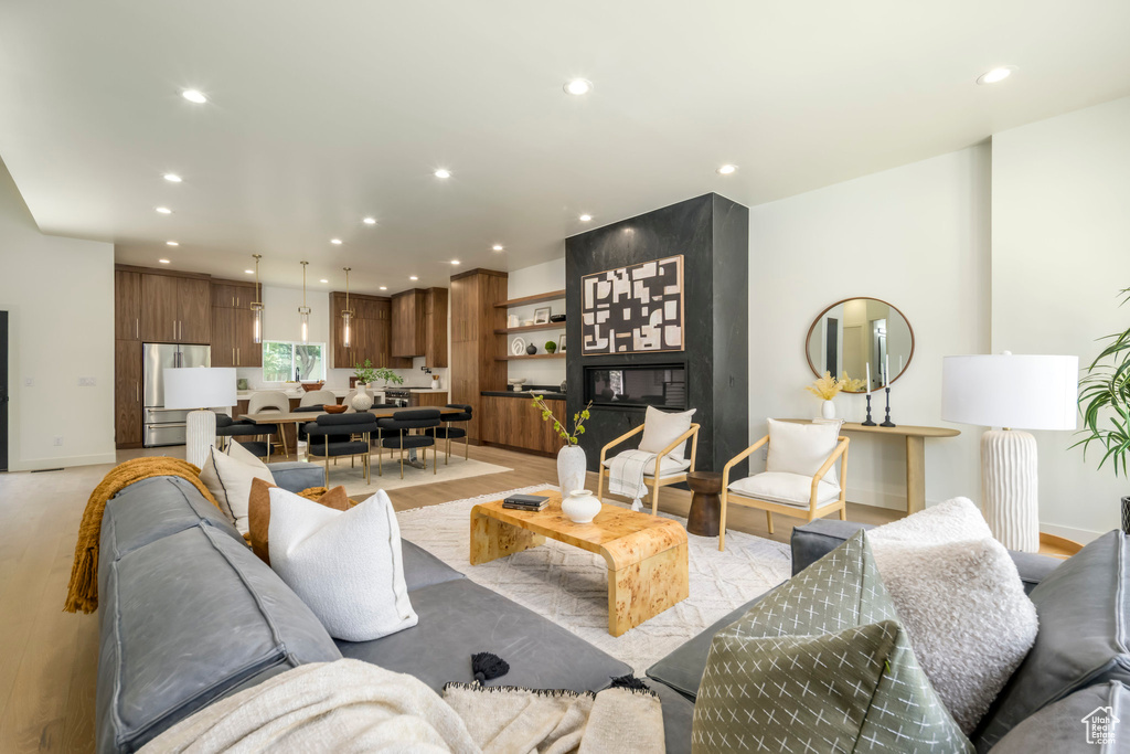Living area featuring light wood-style floors and recessed lighting