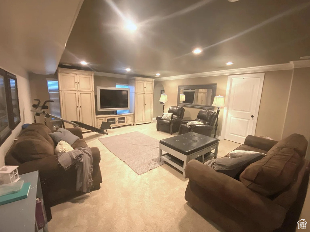 Living area featuring ornamental molding, light carpet, and recessed lighting