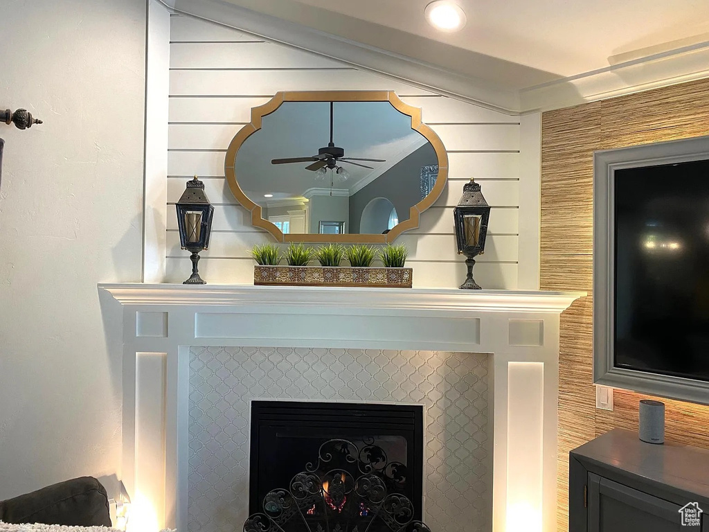Detailed view of ceiling fan and a tile fireplace