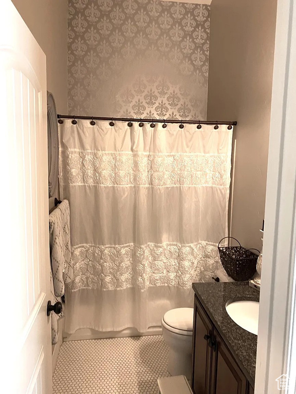 Full bathroom featuring vanity and tile patterned flooring
