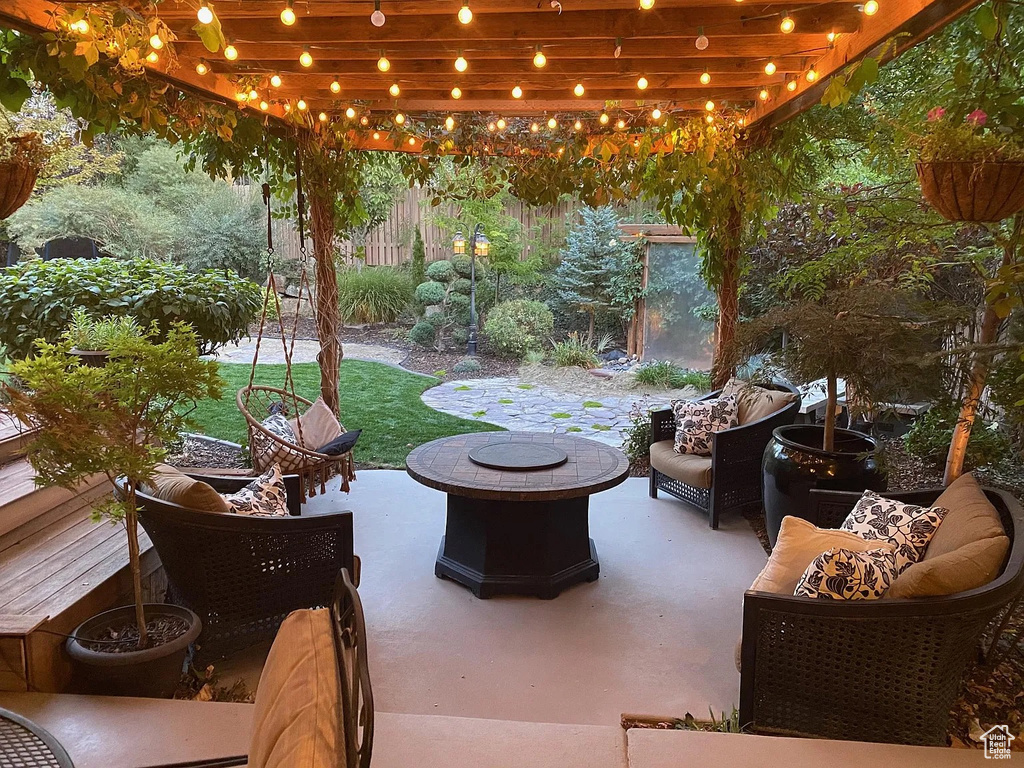 View of patio with an outdoor living space with a fire pit