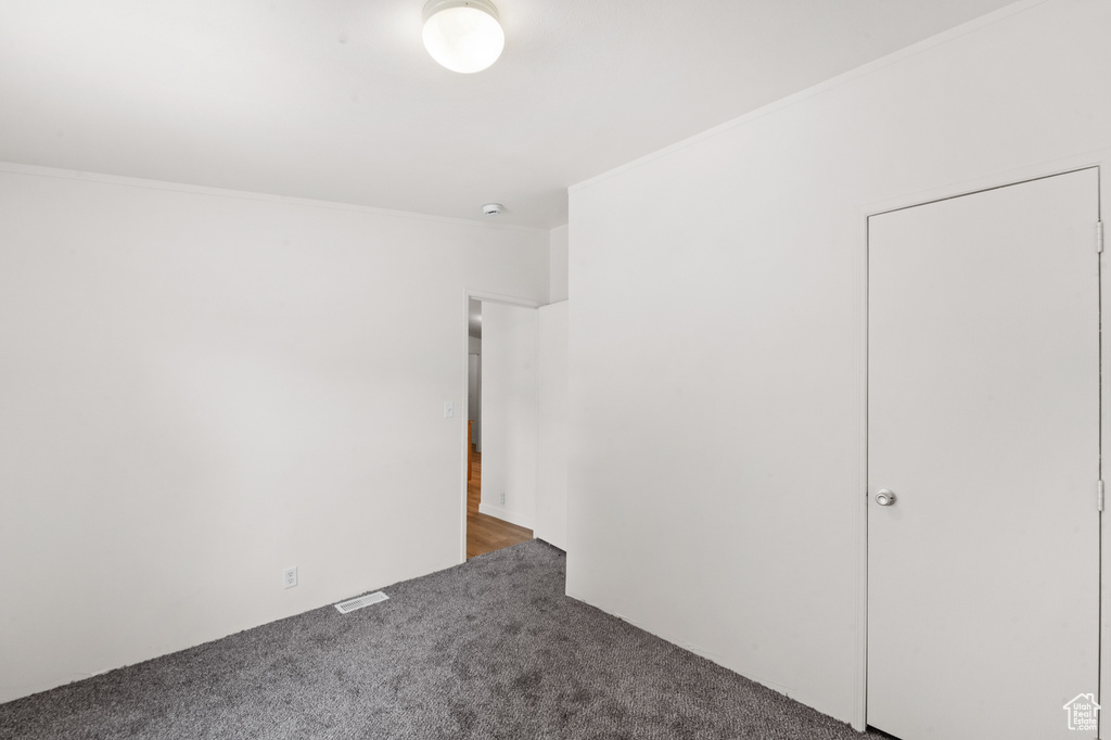 Unfurnished bedroom featuring carpet floors and crown molding