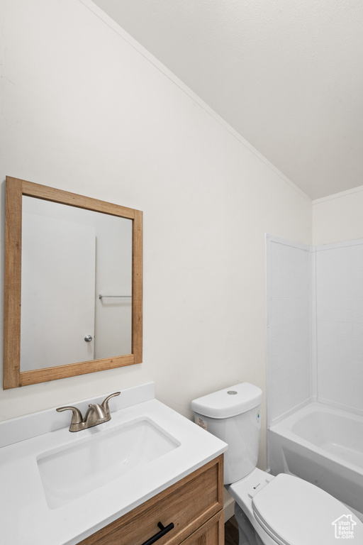 Full bath with vanity, a bath, crown molding, and vaulted ceiling