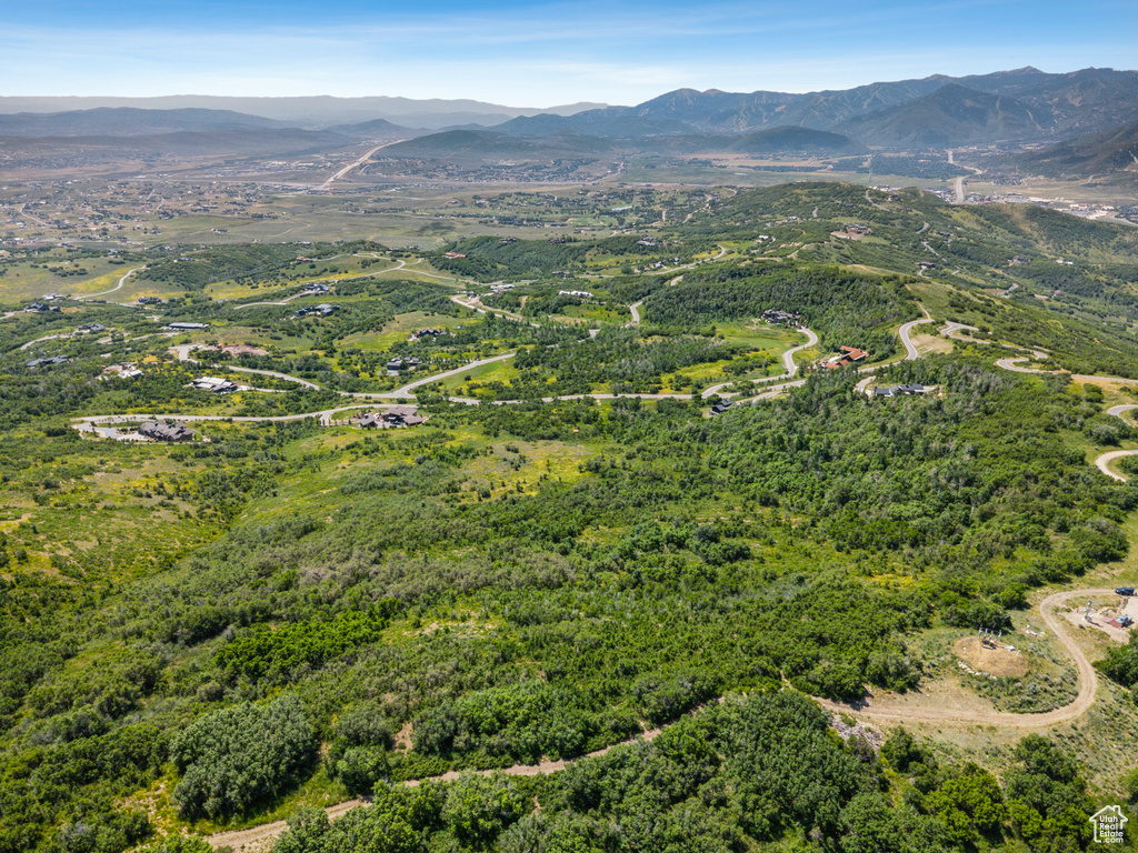 Aerial view of property's location featuring a mountain backdrop