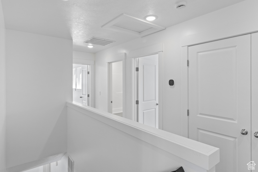 Hall featuring attic access