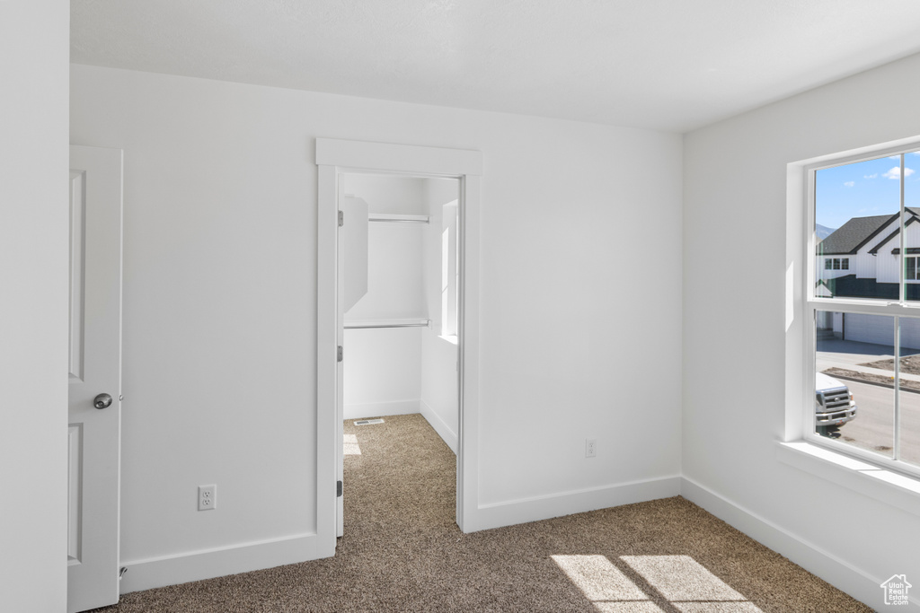 Unfurnished room with carpet and baseboards