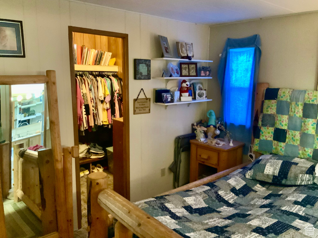 Bedroom featuring a walk in closet and a closet